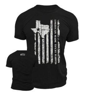 Black t-shirt featuring distressed American flag design on back with Texas state outline integrated into the flag stripes and vertical text reading "AMERICAN MADE, TEXAS RAISED." Front shows Big T's logo on chest. Patriotic Texas pride apparel from veteran-owned business.