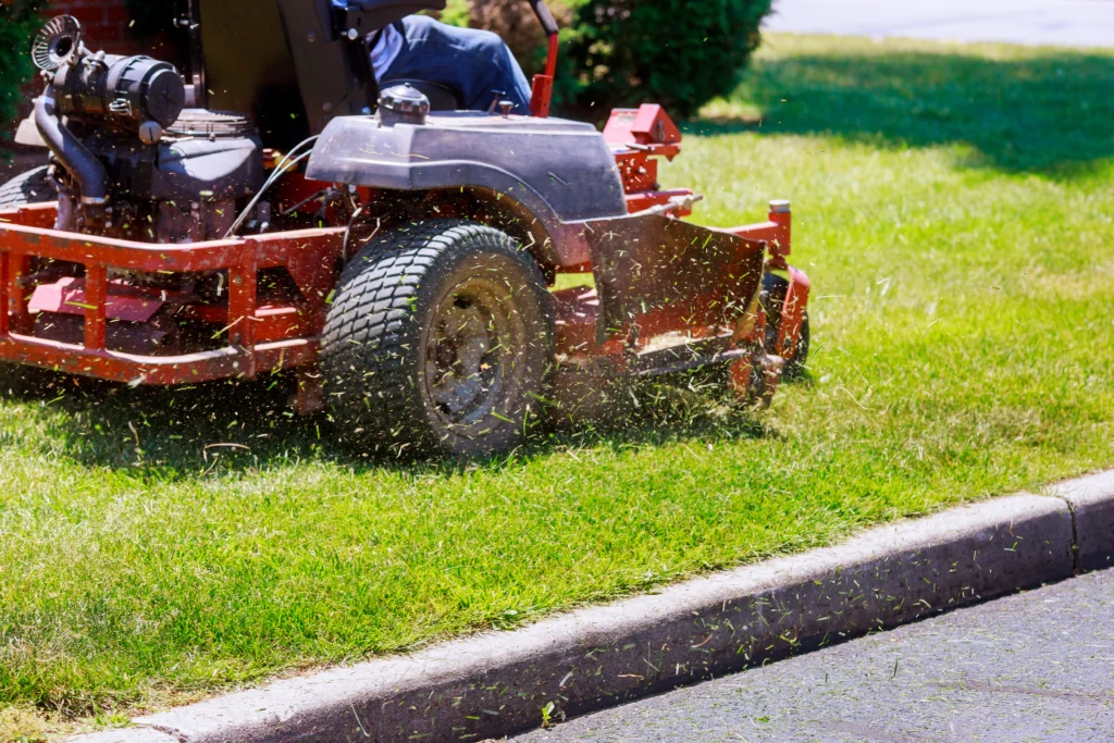 Riding lawnmower cutting grass