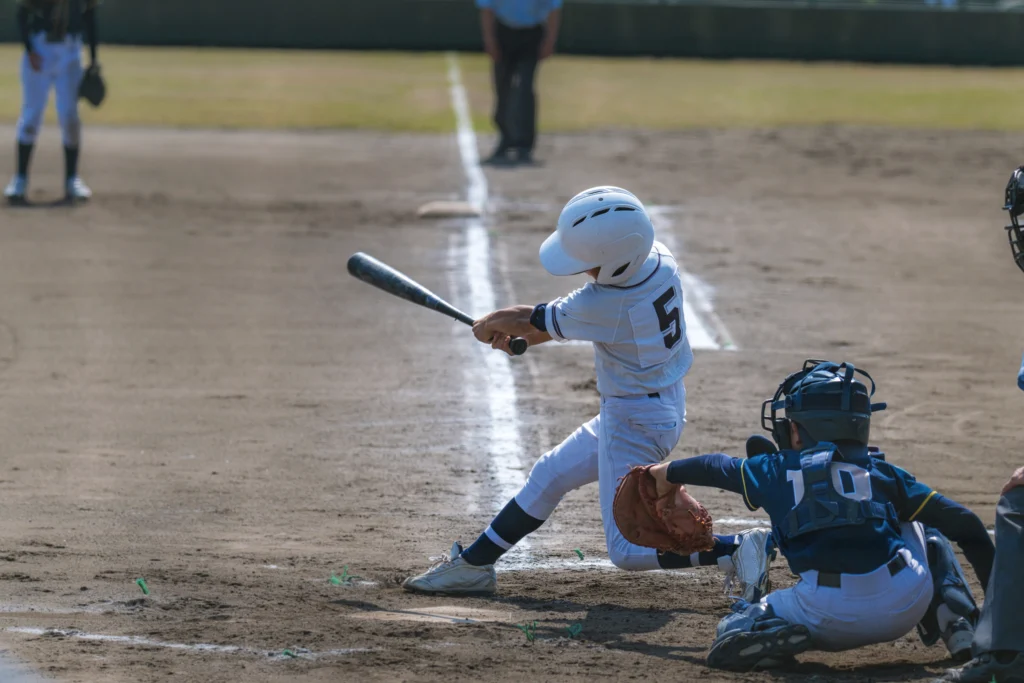 kids in uniforms playing baseball